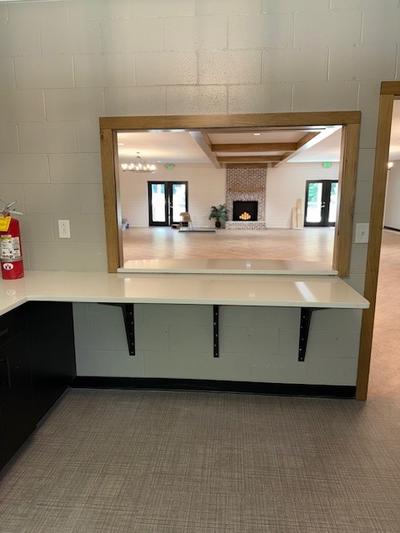 Natural Wood Frame Serving Window with a Countertop Extension 